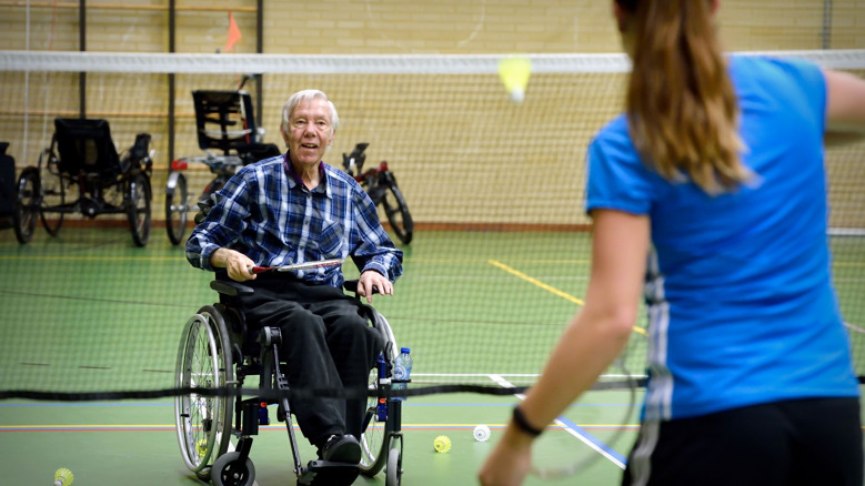 Man in rolstoel speelt badminton